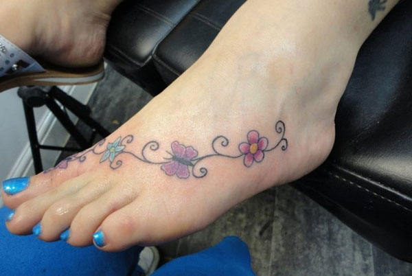 Small Butterfly And Flowers Tattoo On Foot For Girls