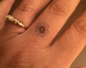 Small Daisy Flower Tattoo On Finger