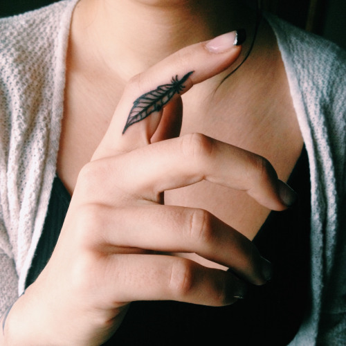 Small Feather Tattoo On Girl Finger