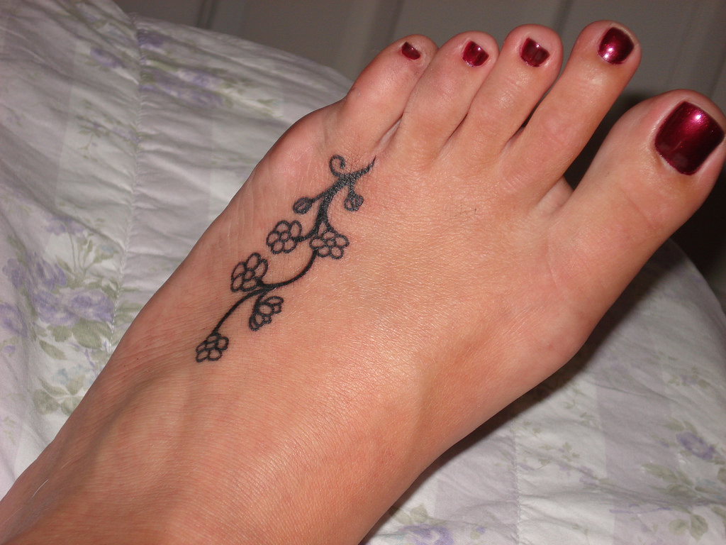 Small Flower Vine Tattoo On Girl Foot