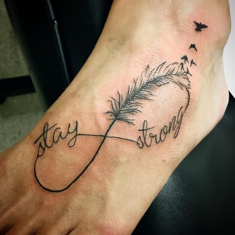 Stay Strong Infinity With Feather Tattoo On Foot