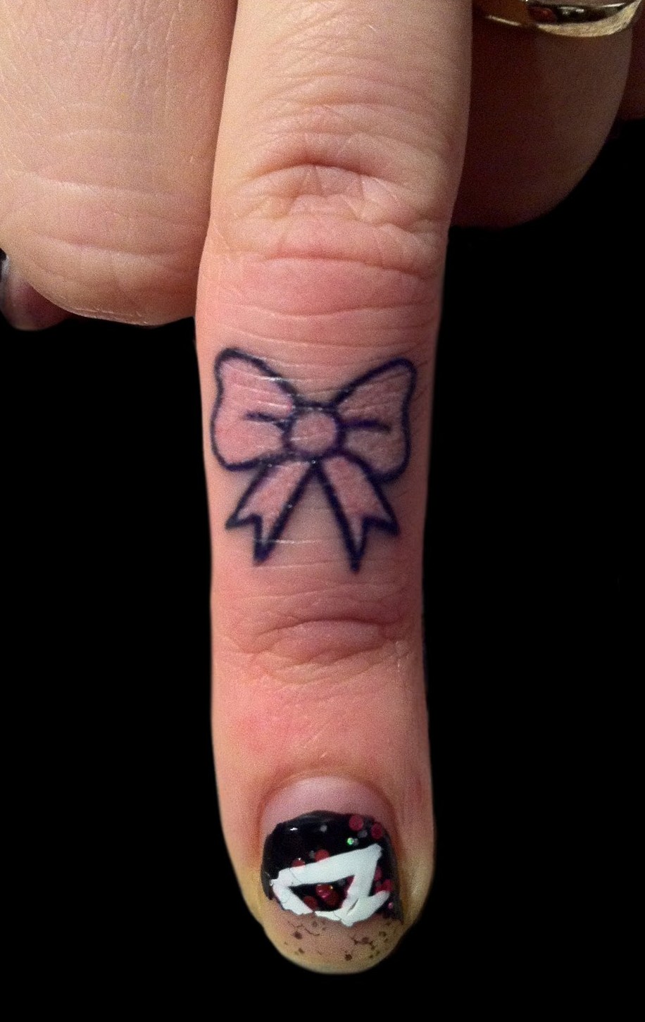 Stylish Pink Bow Tattoo On Girl Finger