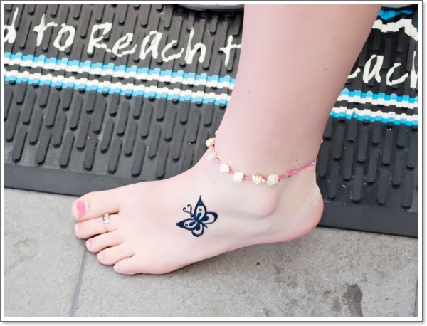 Tiny Black Butterfly Tattoo On Girl Foot