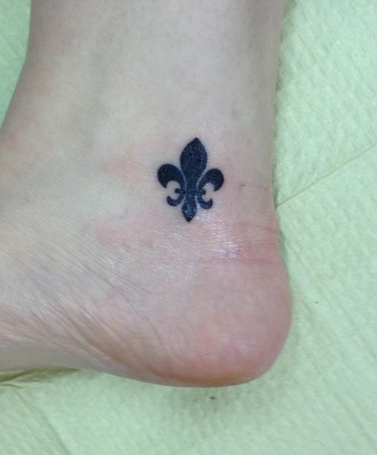 Tiny Black Fleur De Lis Tattoo On Ankle