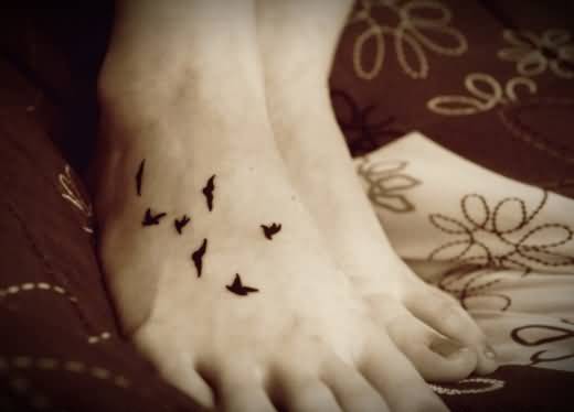 Tiny Black Ink Flying Birds Foot Tattoo For Girls