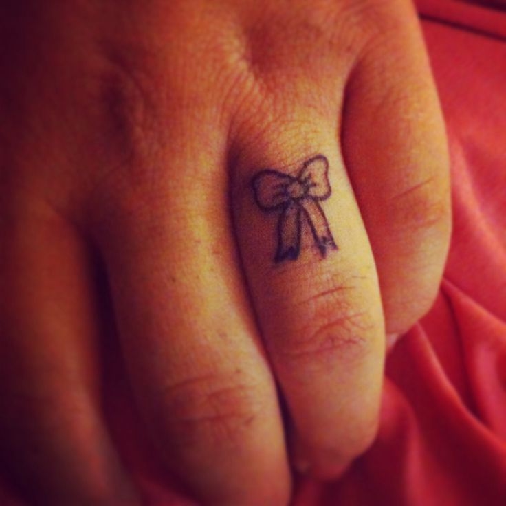 Tiny Bow Finger Tattoo