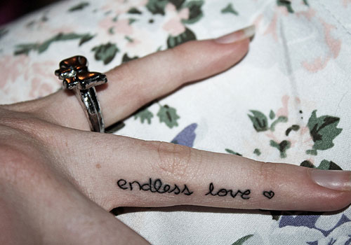 Tiny Heart And Endless Love Tattoo On Girl Side Finger