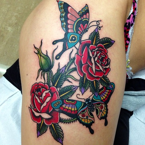 Traditional Butterfly And Roses Tattoo On Thigh