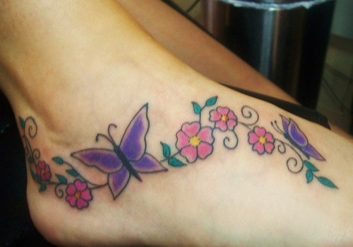 Traditional Flowers Butterflies Tattoo On Foot