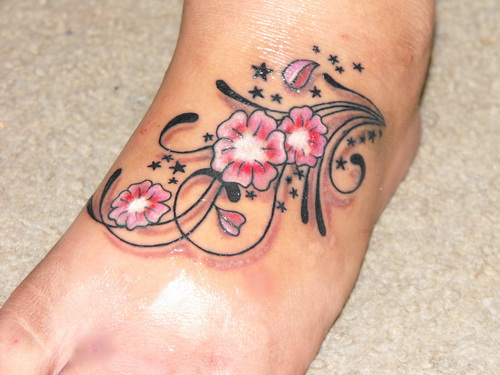 Traditional Pink Flowers Tattoo On Foot