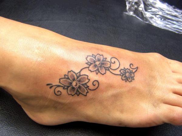 Traditional Small Flowers Tattoo On Foot