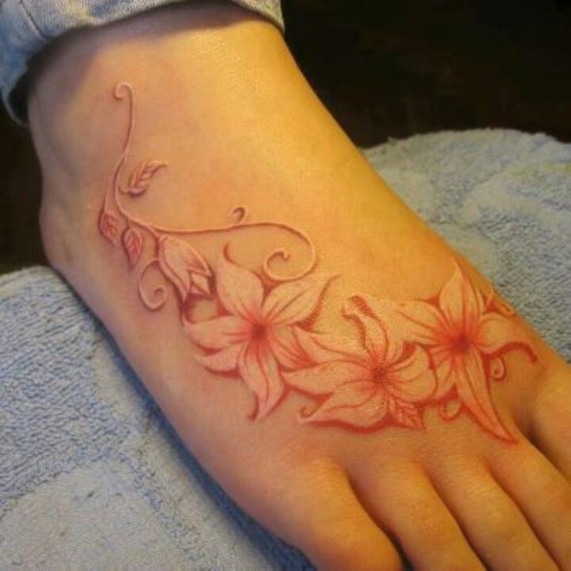 White And Red Ink Flowers Tattoo On Foot