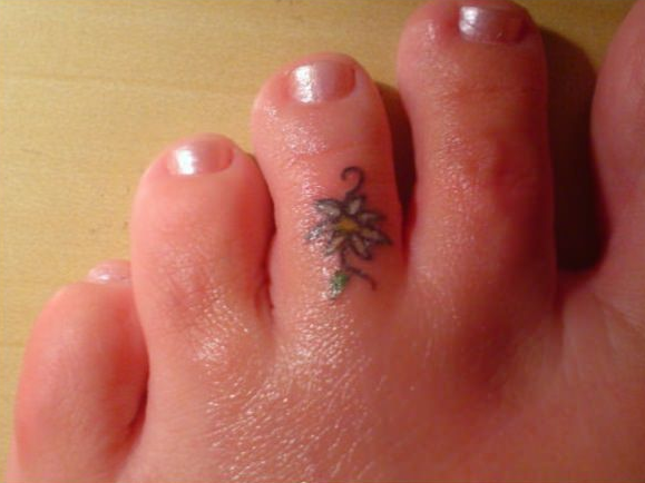 White Flower Tattoo On Foot Finger