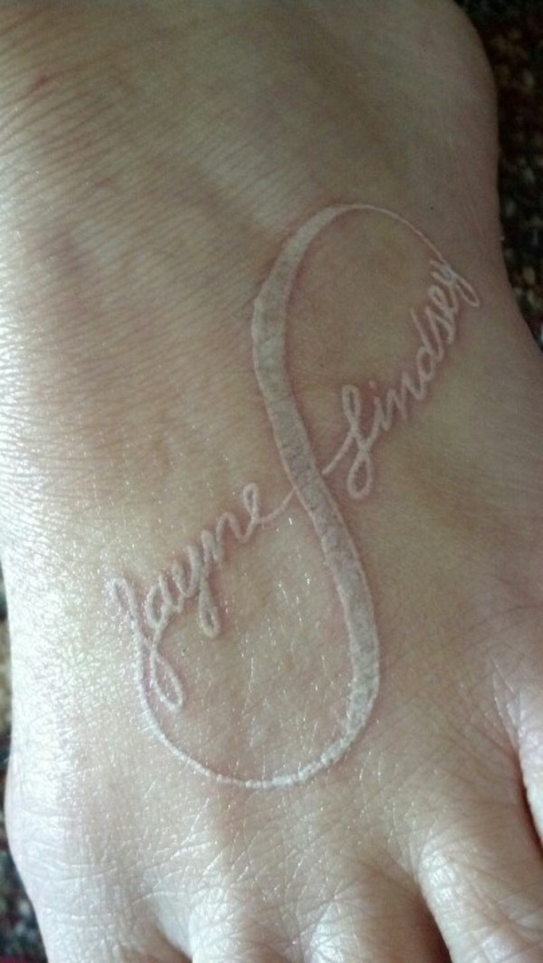 White Ink Infinity Names Tattoo On Foot