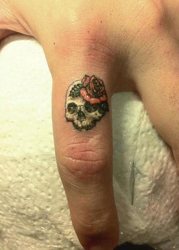 White Skull And Rose Flower Tattoo On Finger