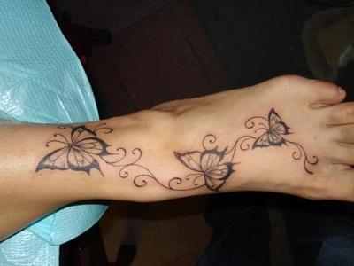 Wonderful Swirly Black Butterflies Tattoo On Foot By Dean