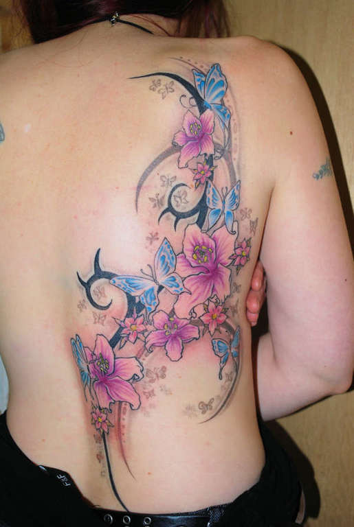 Wonderful Tribal Butterfly With Flowers Back Tattoo