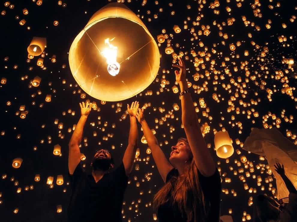 A Couple Releasing Lantern At The Yi Peng Lantern Festival