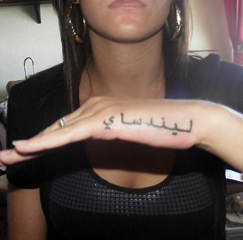 Arabic Tattoo On Girl Side Hand