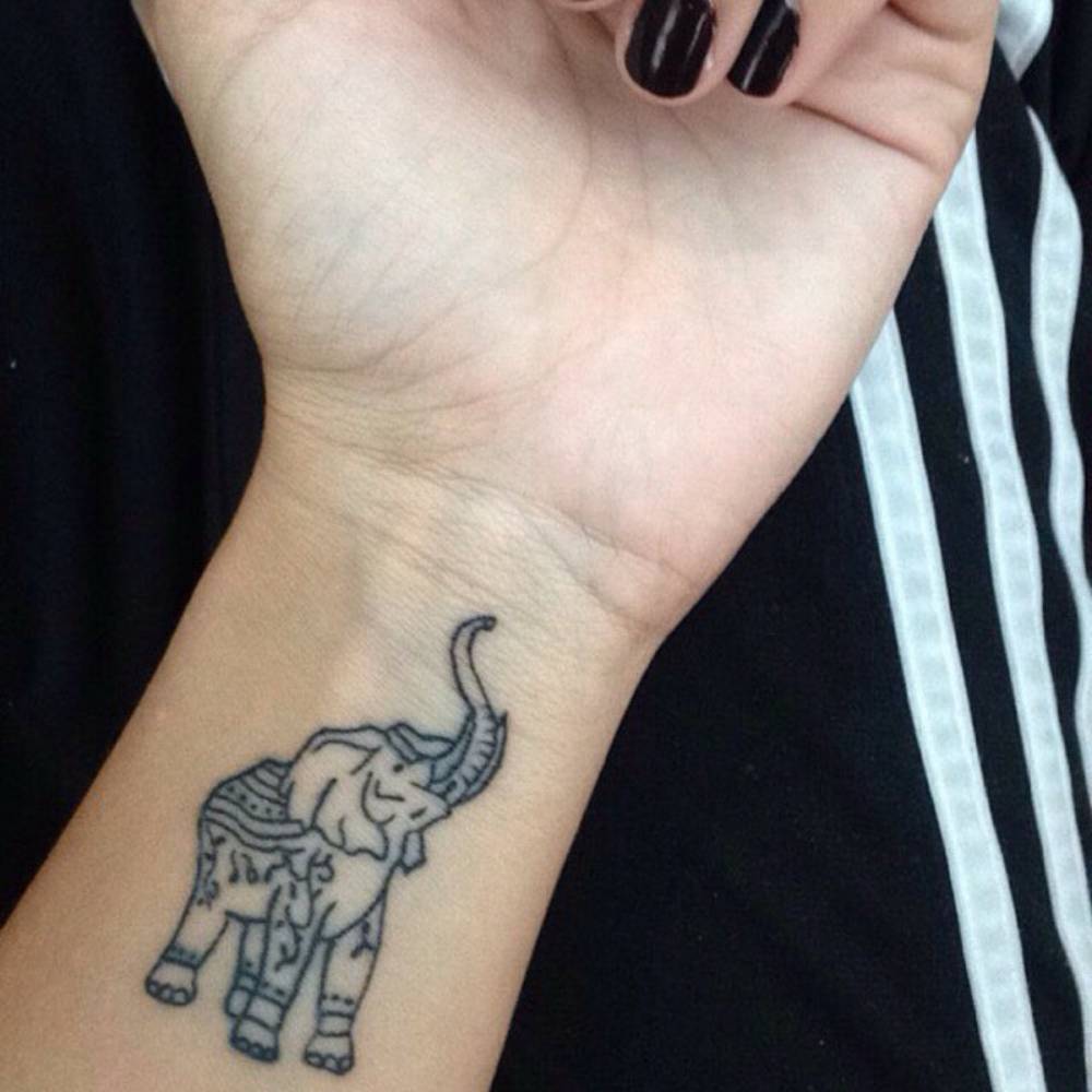 Attractive Elephant Trunk Up Tattoo On Girl Left Wrist