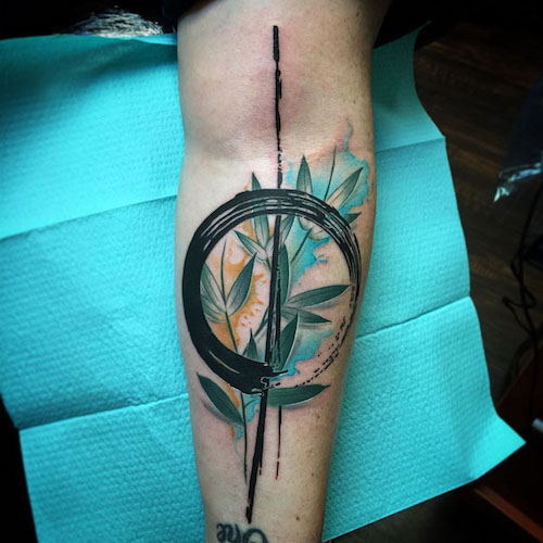 Attractive Zen Circle With Leaves Tattoo On Forearm