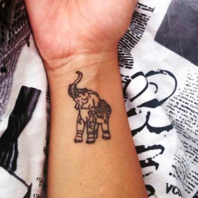 Awesome Black Elephant Trunk Up Tattoo On Right Wrist