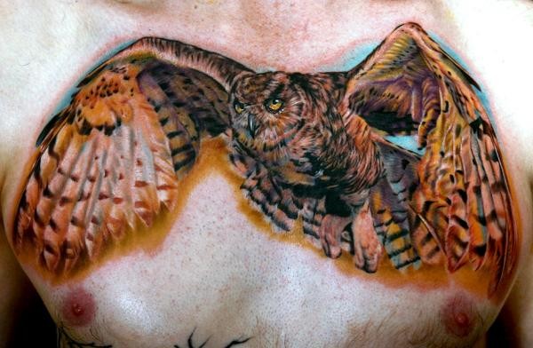 Awesome Colored Flying Owl Tattoo On Chest For Men