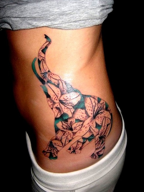 Awesome Flowers In Chinese Elephant Trunk Up Tattoo On Girl Left Side Rib