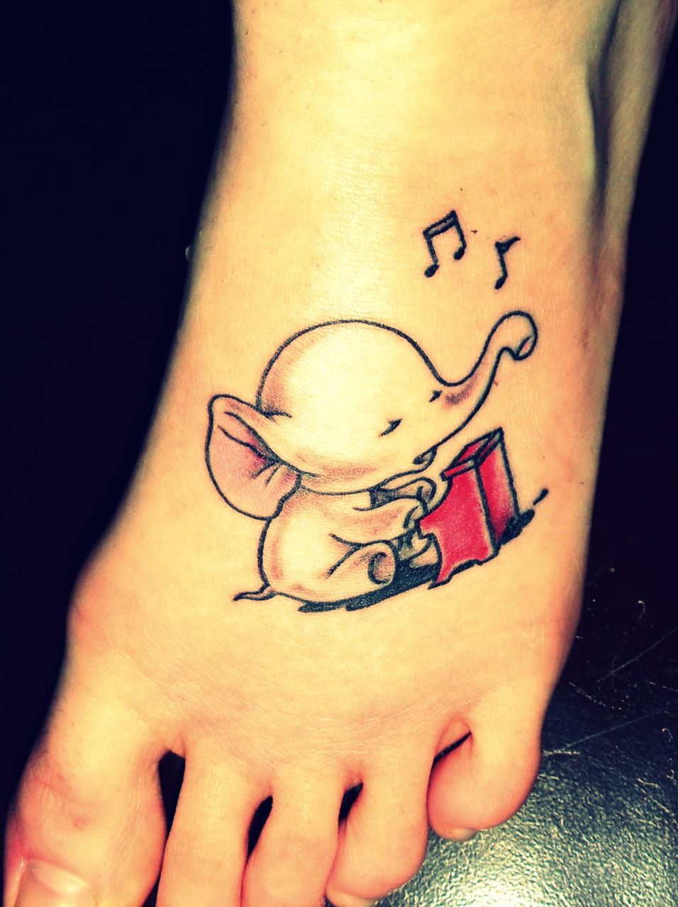 Beautiful Baby Elephant Playing Piano Tattoo On Left Foot