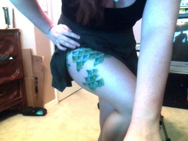 Beautiful Green Ink Mermaid Scale Tattoo On Girl Right Thigh