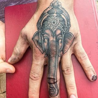 Black And Grey Crown On Elephant Head Tattoo On Hand