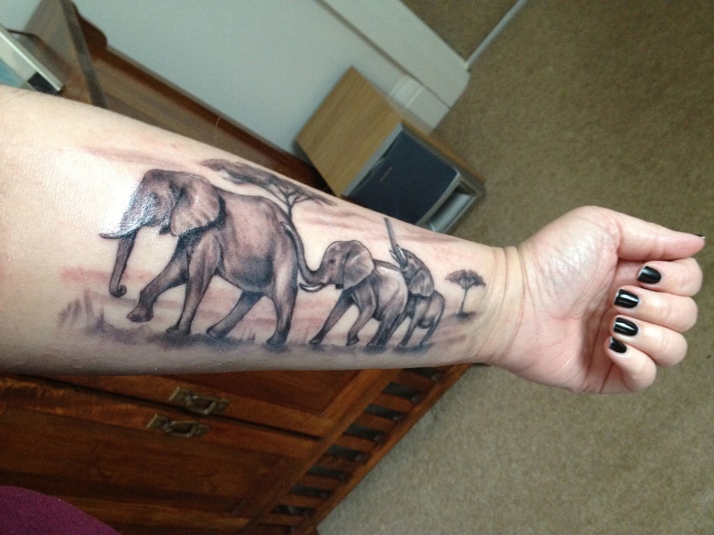 Black And Grey Elephant Family Tattoo On Girl Left Forearm