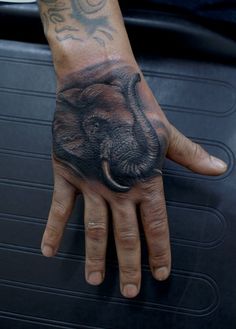 Black And Grey Elephant Head Trunk Up Tattoo On Right Hand