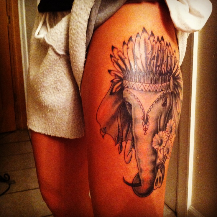 Black And Grey Elephant Headdress Flowers Tattoo On Girl Left Thigh