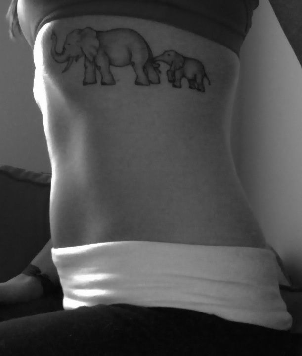 Black And Grey Elephant With Baby Elephant Tattoo On Girl Side Rib