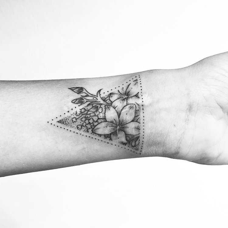 Black And Grey Flowers In Triangle Tattoo On Wrist