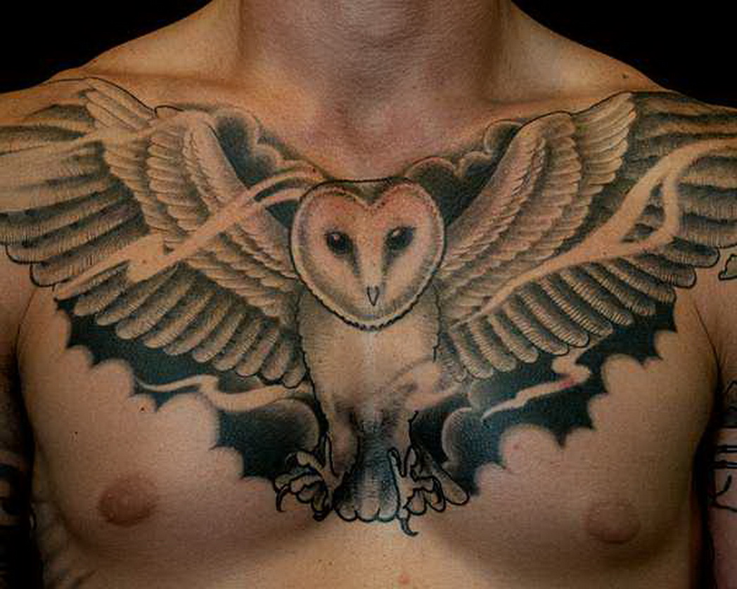 Black And Grey Flying Owl Tattoo On Man Chest