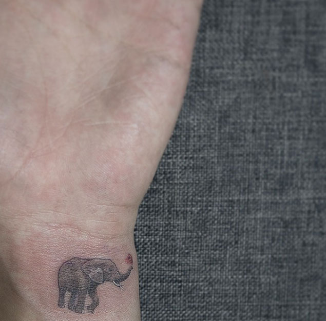 Black And Grey Little Elephant Tattoo On Left Wrist By Sol Art