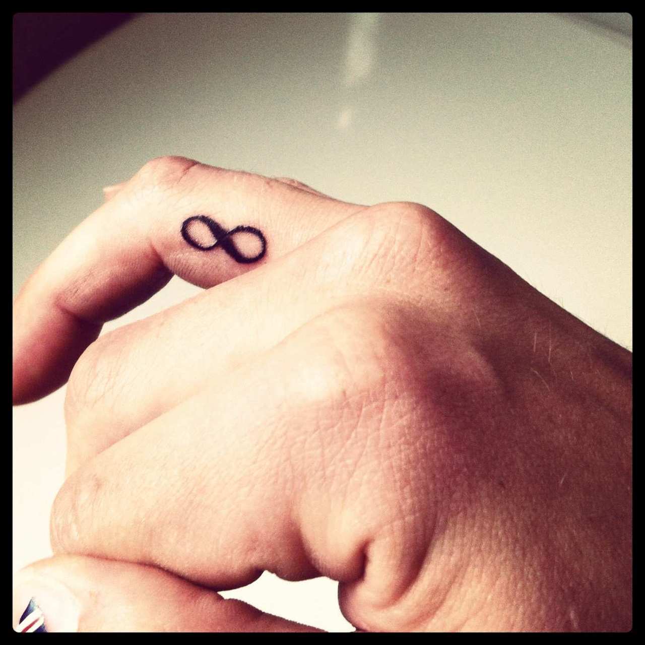 Black Infinity Tattoo On Side Finger