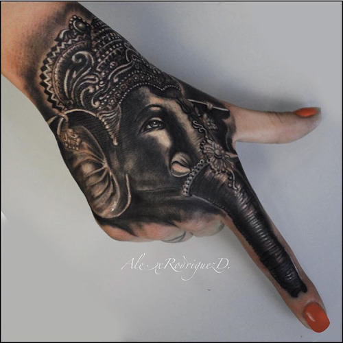 Black Ink Crown On Elephant Head Tattoo On Girl Right Hand