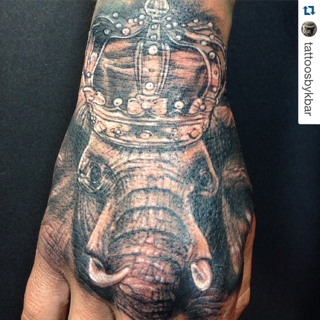 Black Ink Crown On Elephant Head Tattoo On Hand
