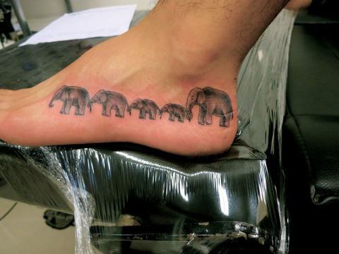 Black Ink Elephant Family Tattoo On Left Foot