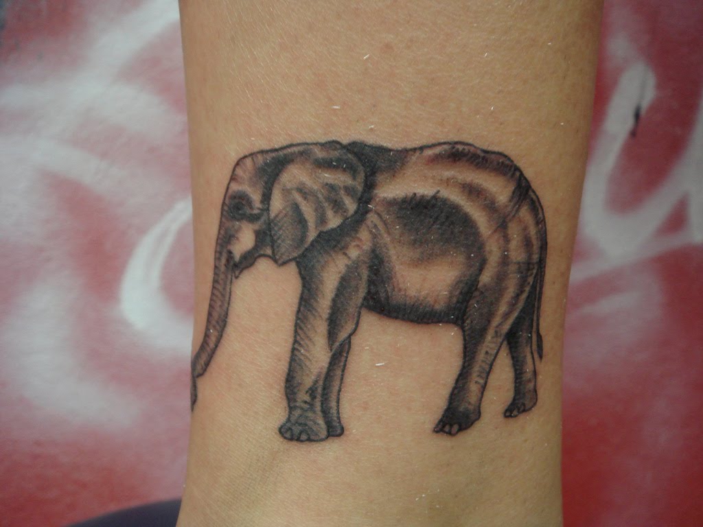 Black Ink Elephant Tattoo Design For Arm