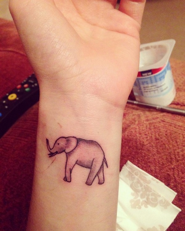 Black Ink Elephant Trunk Up Tattoo On Left Wrist