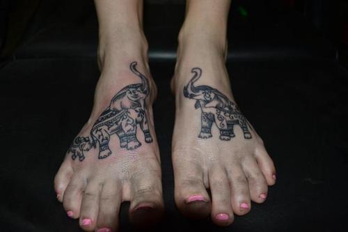 Black Ink Elephant With Baby Elephant Tattoo On Girl Feet
