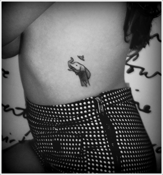 Black Ink Elephant With Flying Bird Tattoo On Girl Left Side Rib