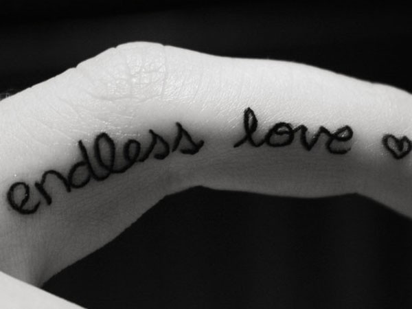 Black Ink Endless Love Tattoo On Side Finger