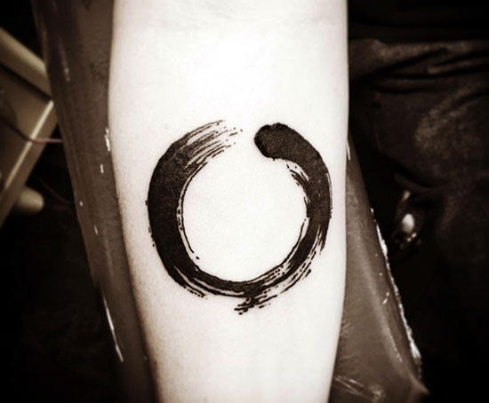 Black Ink Zen Circle Tattoo On Forearm
