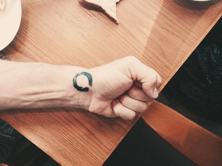 Black Ink Zen Circle Tattoo On Left Wrist