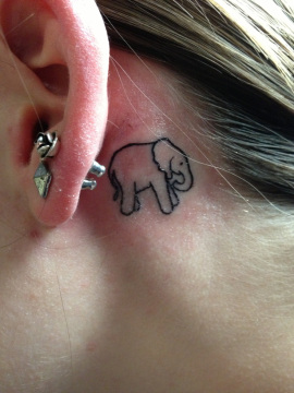 Black Outline Elephant Tattoo On Girl Left Behind The Ear